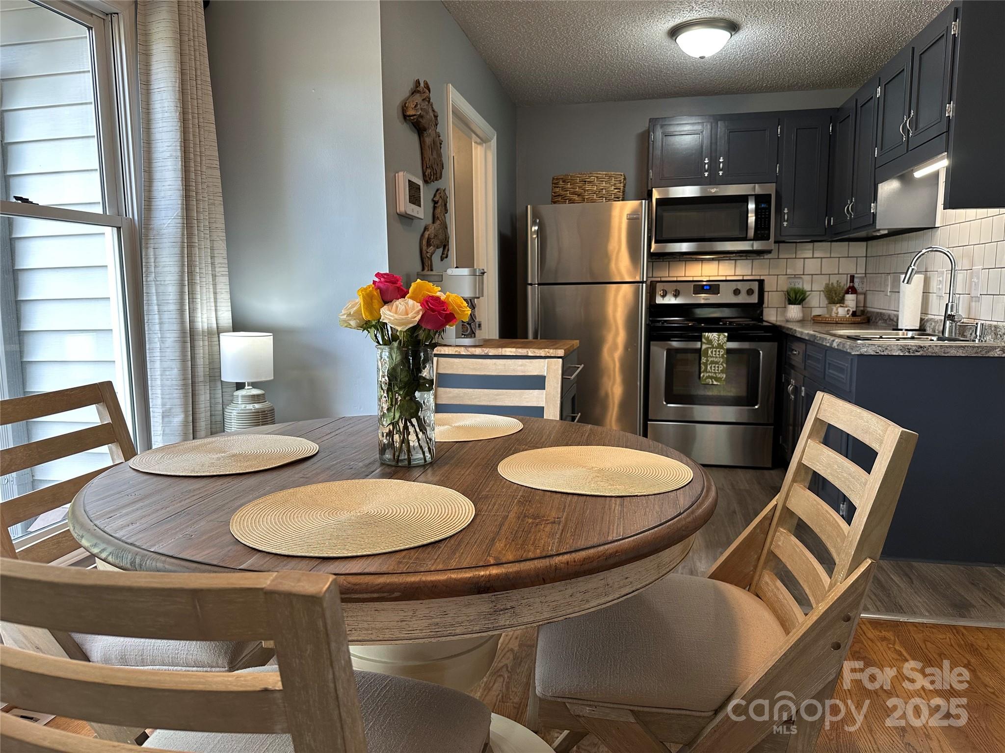 102 Stephens Drive Morganton, NC 28655 - Photo 14 of 48 a kitchen with stainless steel appliances granite countertop a sink and a refrigerator