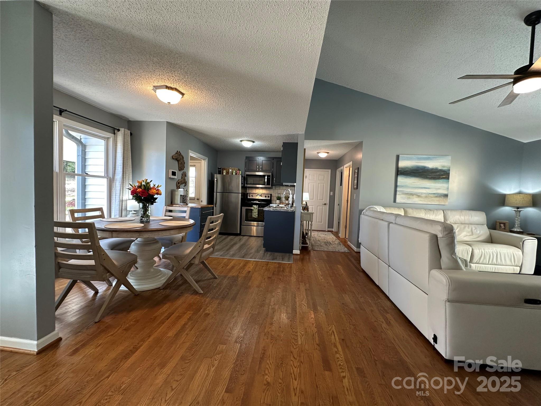 102 Stephens Drive Morganton, NC 28655 - Photo 15 of 48 a living room with furniture a wooden floor and a kitchen