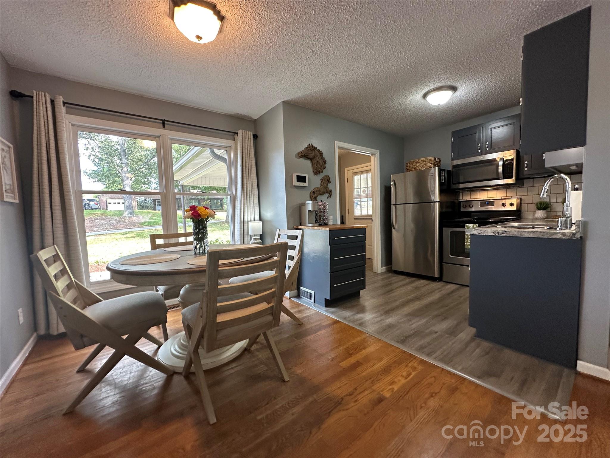 102 Stephens Drive Morganton, NC 28655 - Photo 16 of 48 a view of a dining room with furniture window and outside view