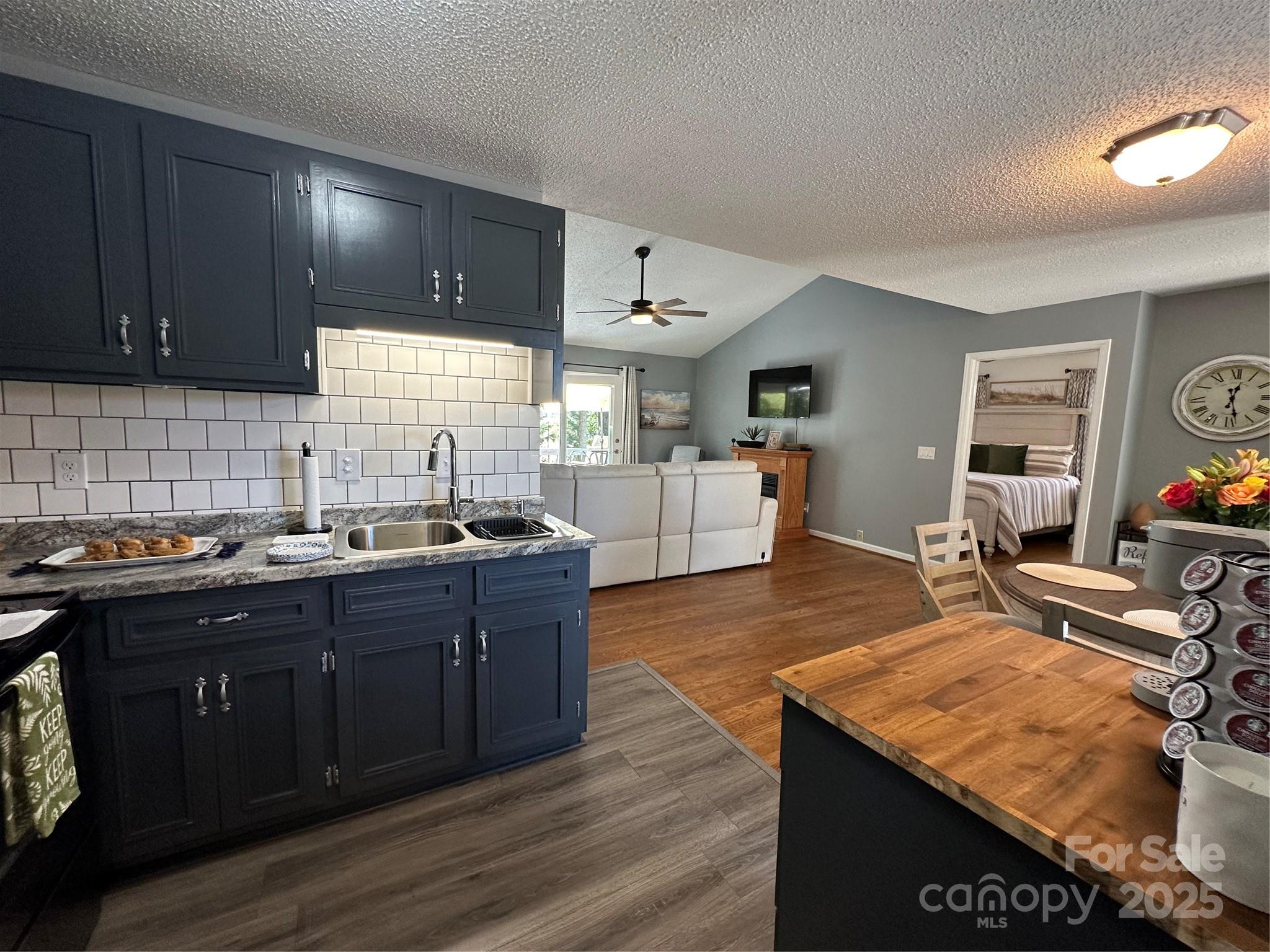 102 Stephens Drive Morganton, NC 28655 - Photo 18 of 48 a kitchen with stainless steel appliances granite countertop a stove a sink dishwasher and cabinets with wooden floor