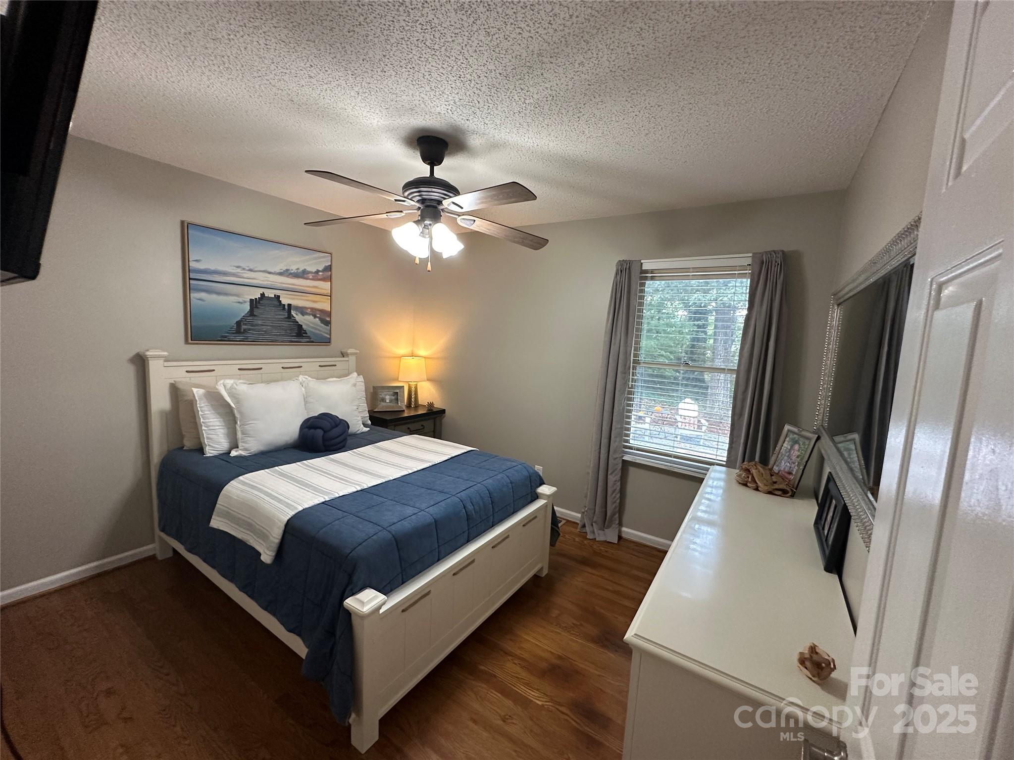 102 Stephens Drive Morganton, NC 28655 - Photo 21 of 48 a bedroom with a bed and a chandelier