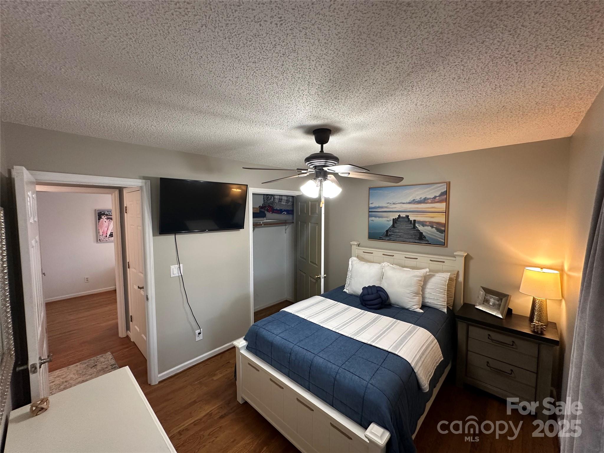 102 Stephens Drive Morganton, NC 28655 - Photo 22 of 48 a bedroom with a bed and a chandelier