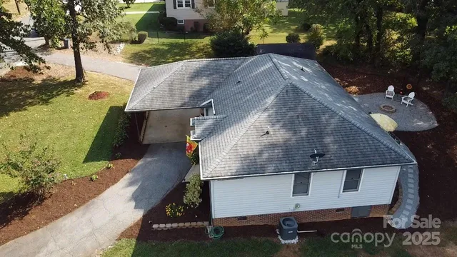 a view of house with backyard and outdoor seating