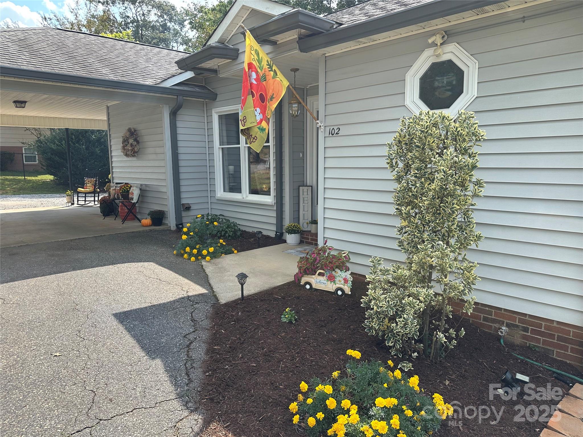 102 Stephens Drive Morganton, NC 28655 - Photo 34 of 48 a potted plant sitting in front of a house