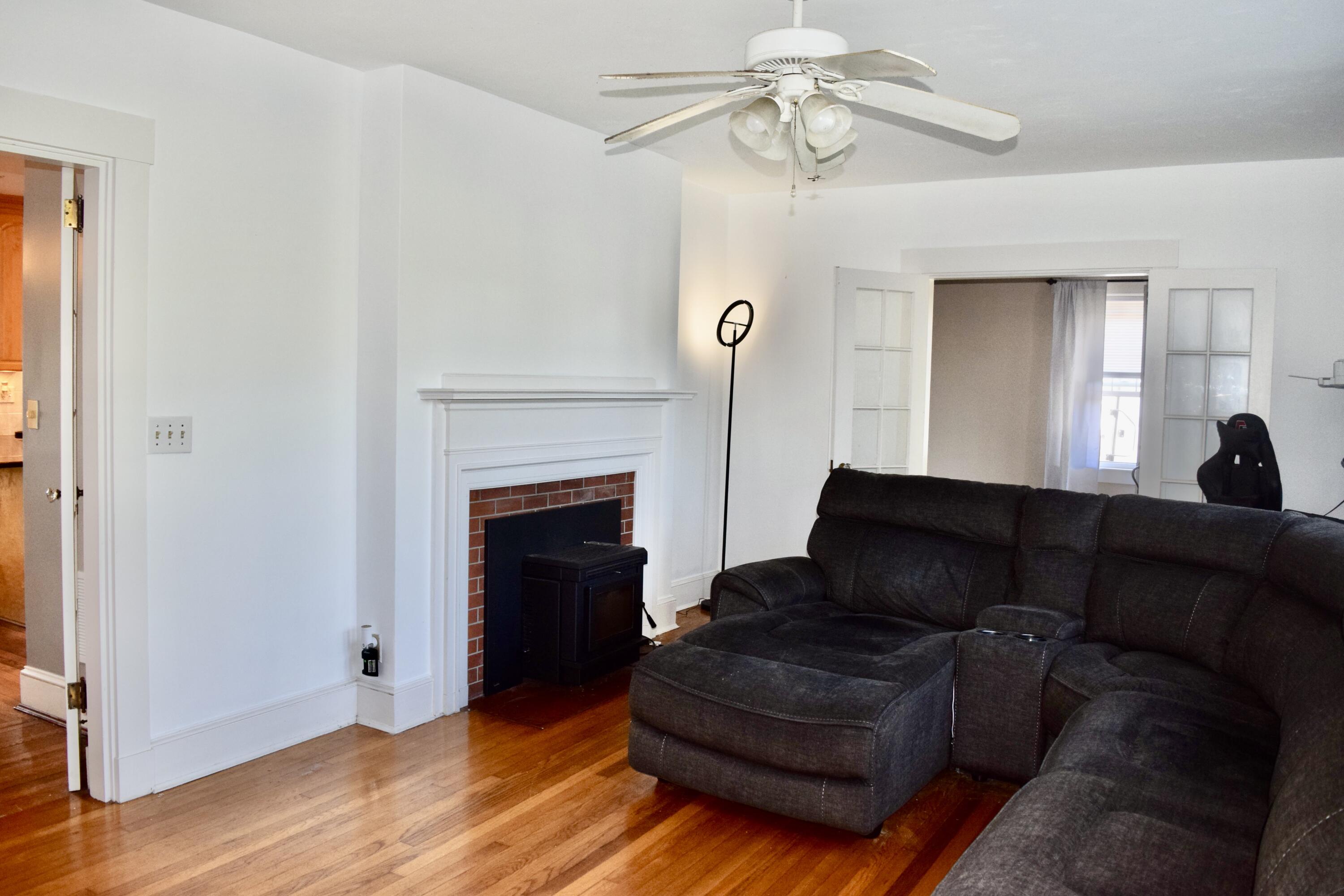 99 South Main Street Acushnet, MA 02743 - Photo 7 of 46 a living room with furniture and a fireplace