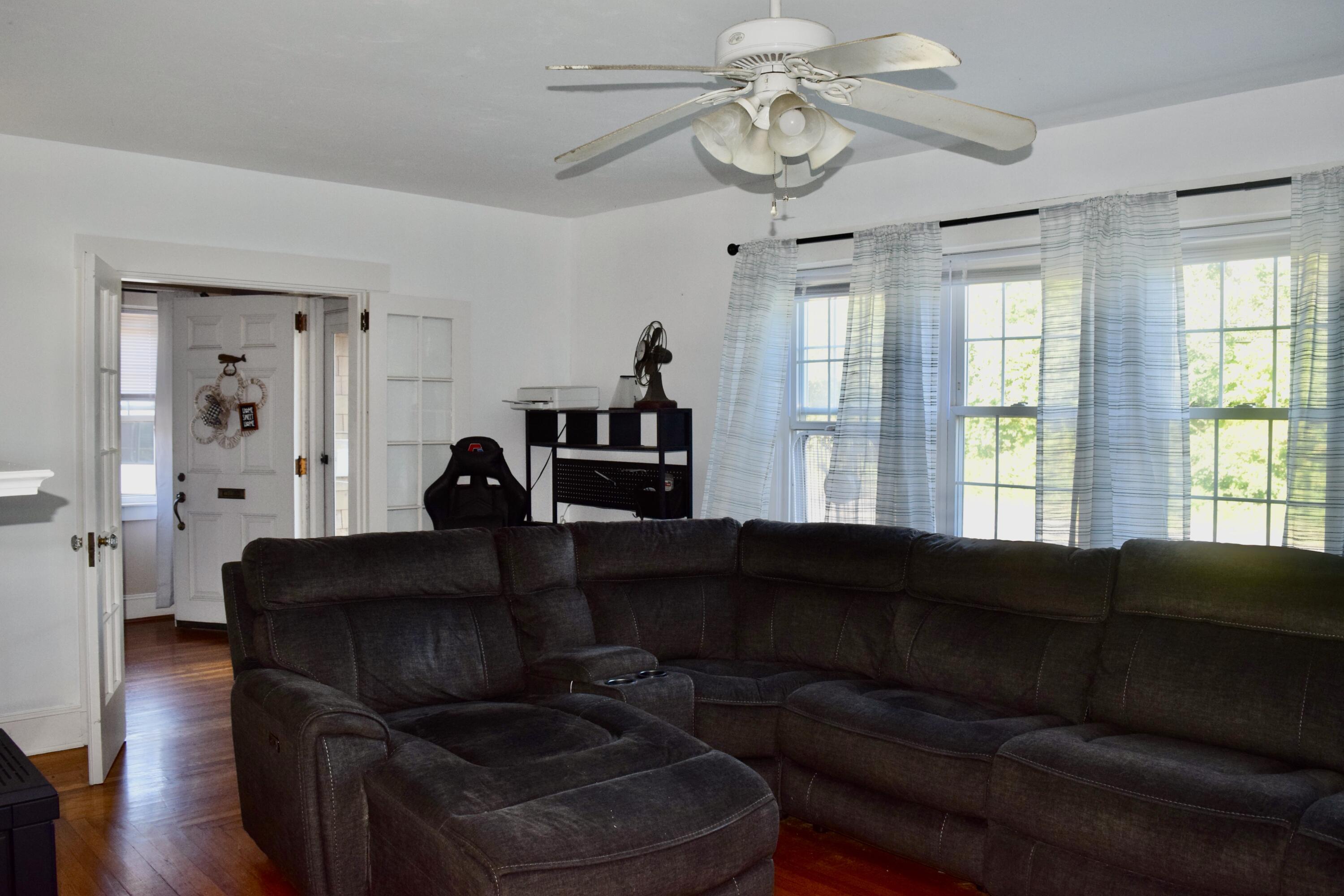 99 South Main Street Acushnet, MA 02743 - Photo 10 of 46 a living room with furniture and a large window