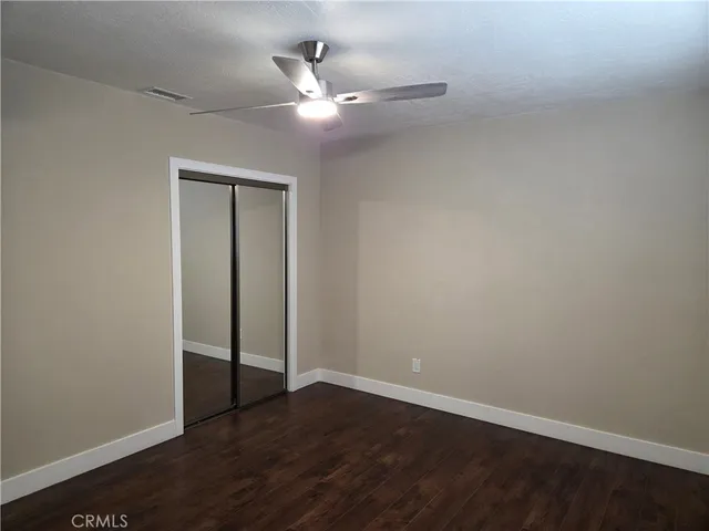 a view of a small space with wooden floor and a window