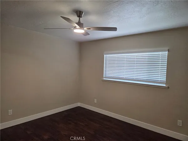a view of a small space with wooden floor and a window