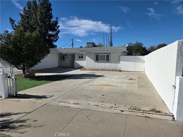 a view of a white house with a yard