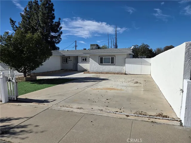 a view of a white house with a yard