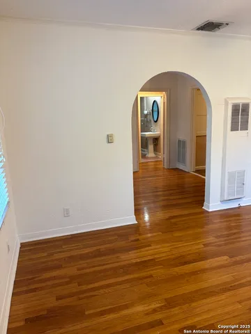 a view of a room with wooden floor