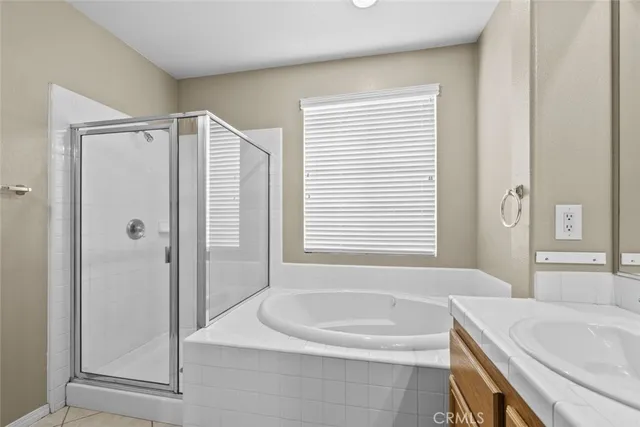 a bathroom with a granite countertop sink and a bathtub