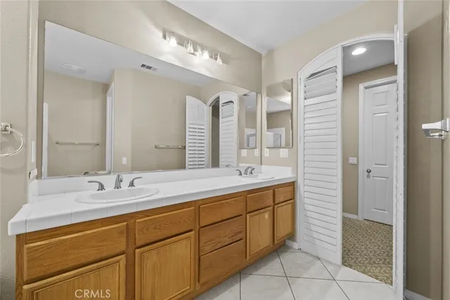 a bathroom with a sink double vanity and a mirror