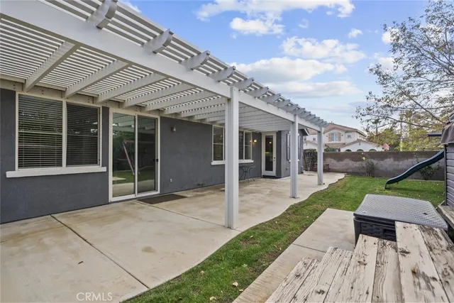 a backyard of a house with entertaining equipment