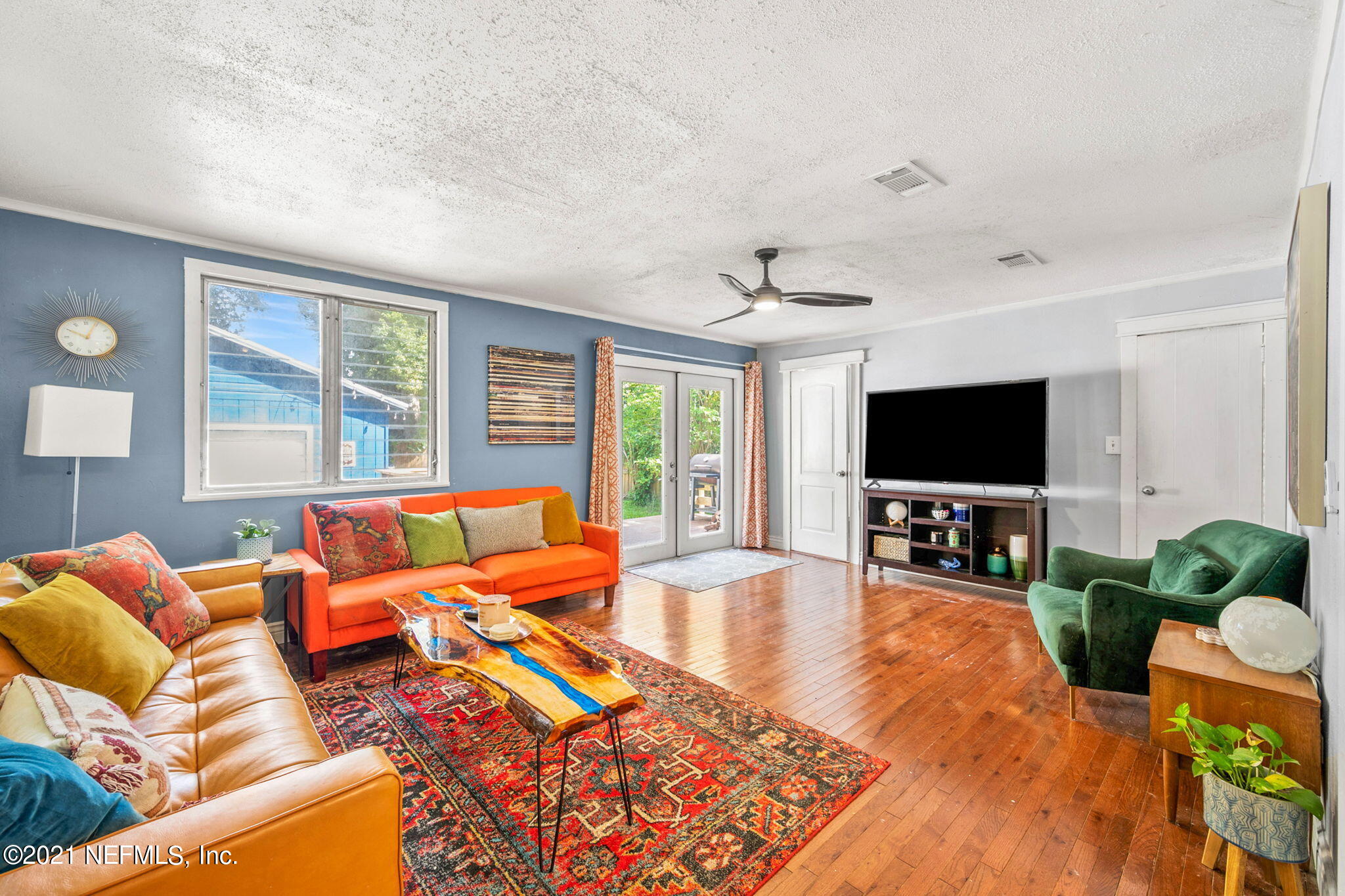 2883 Forbes Street Jacksonville, FL 32205 - Photo 19 of 30 a living room with furniture a flat screen tv and a large window