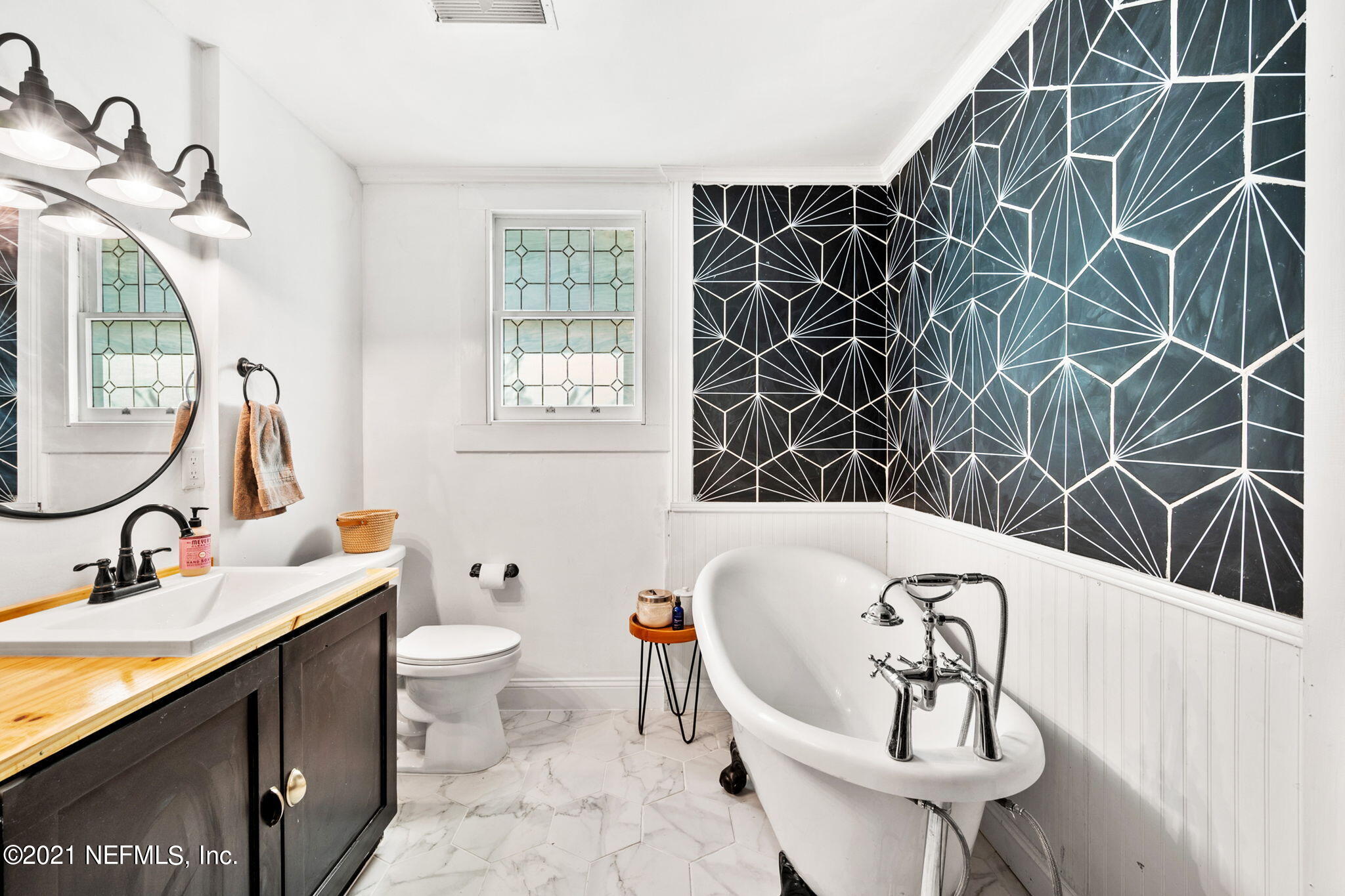 2883 Forbes Street Jacksonville, FL 32205 - Photo 24 of 30 a bathroom with a sink and mirror with toilet
