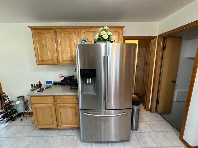 a kitchen with stainless steel appliances granite countertop a refrigerator and a sink