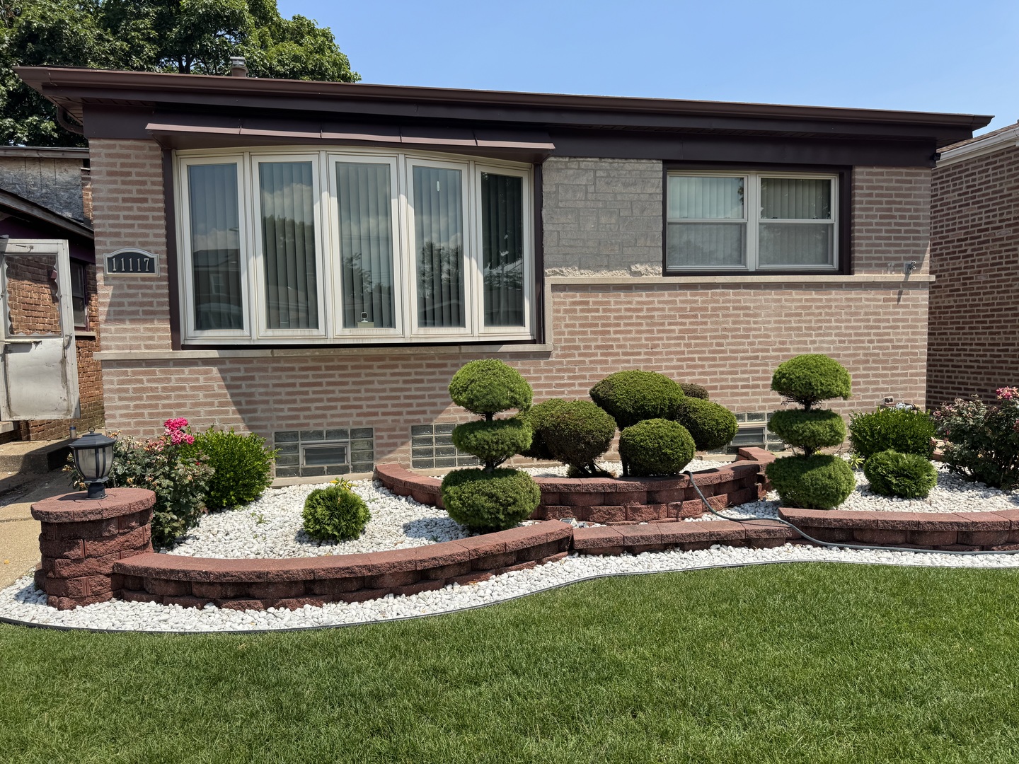 11117 South Ave L Chicago, IL 60617 - Photo 2 of 32 a front view of a house with a yard and outdoor seating