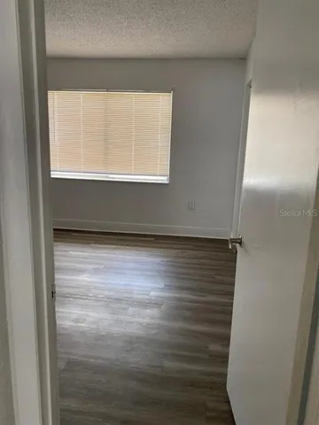 a bathroom with a granite countertop sink and a toilet