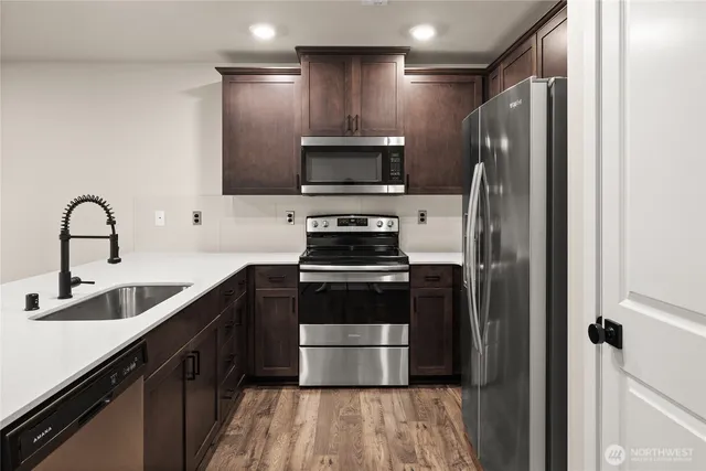 a kitchen with a sink and a stove top oven