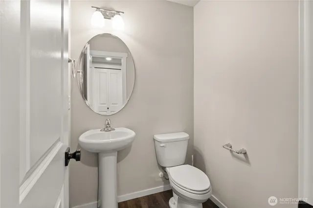 a bathroom with a toilet sink and mirror