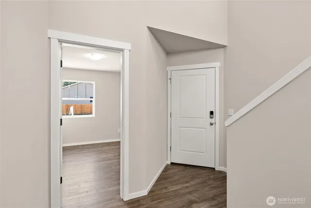 a view of a hallway with wooden floor