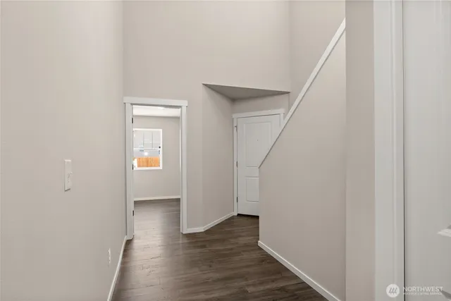 a view of a hallway with wooden floor