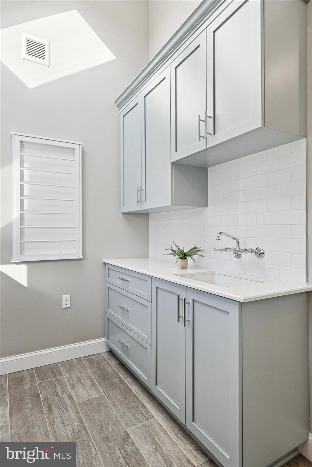 222 Windsor Way Doylestown, PA 18901 - Photo 20 of 42 a kitchen with granite countertop white cabinets and a sink