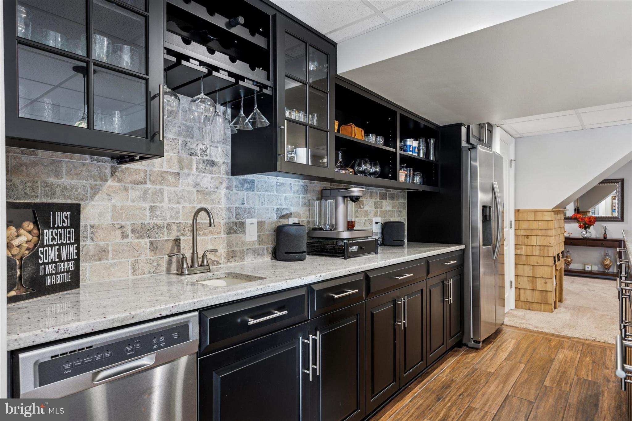 222 Windsor Way Doylestown, PA 18901 - Photo 29 of 42 a kitchen with stainless steel appliances granite countertop a sink and wooden cabinets