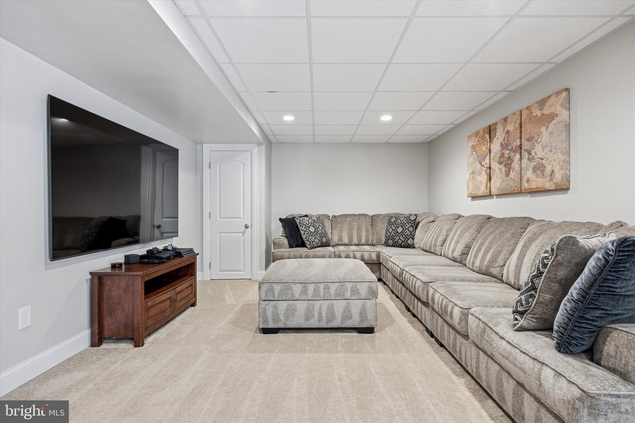 222 Windsor Way Doylestown, PA 18901 - Photo 30 of 42 a living room with furniture and a flat screen tv