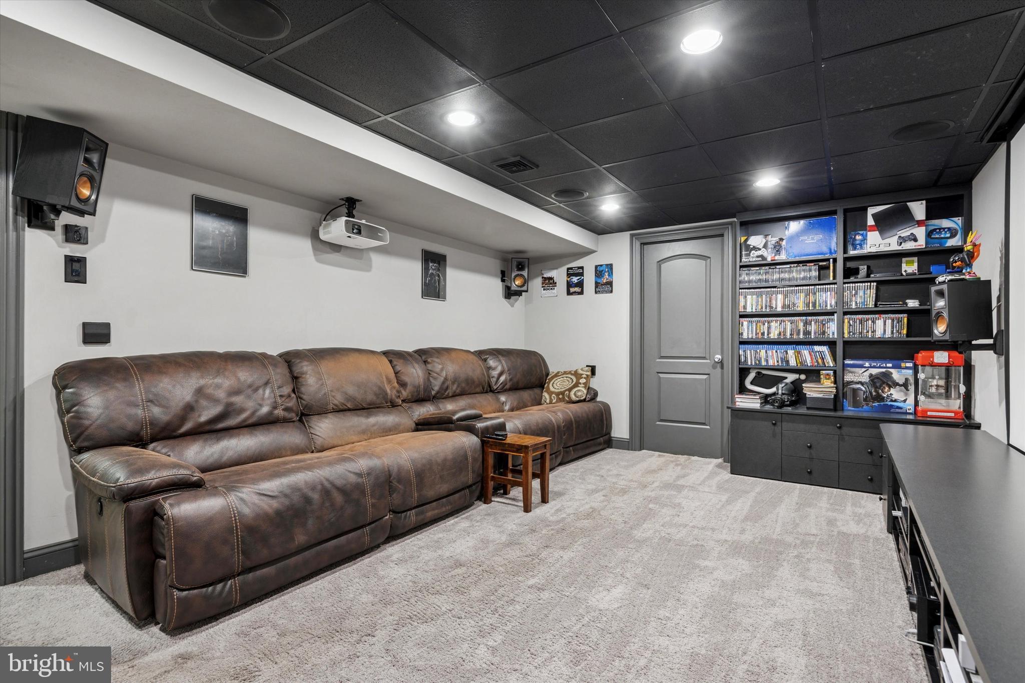 222 Windsor Way Doylestown, PA 18901 - Photo 32 of 42 a living room with furniture and a book shelf