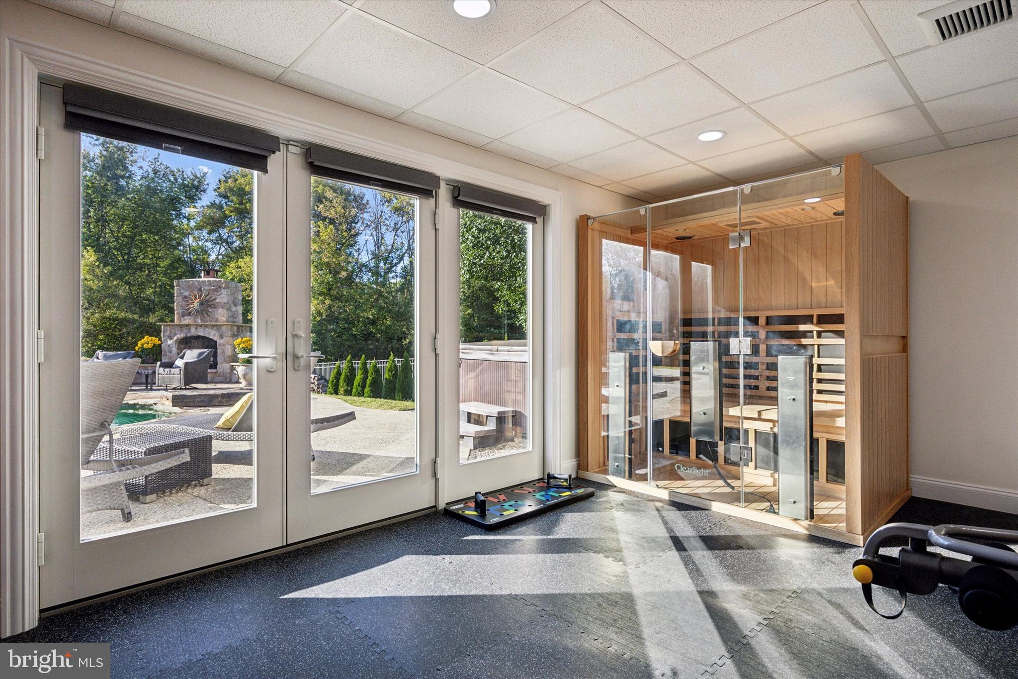 222 Windsor Way Doylestown, PA 18901 - Photo 34 of 42 a view of a room with gym equipment and large windows