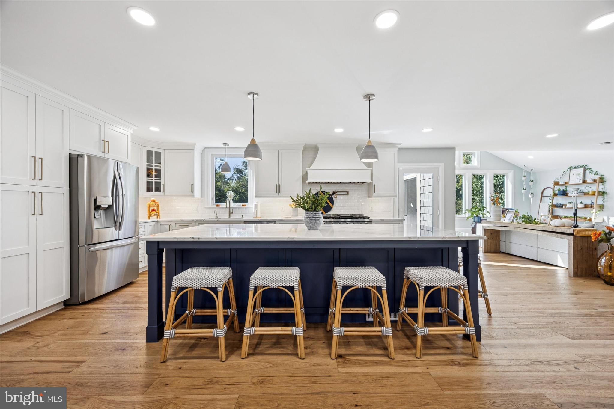 222 Windsor Way Doylestown, PA 18901 - Photo 6 of 42 a kitchen with stainless steel appliances a dining table chairs and wooden floor