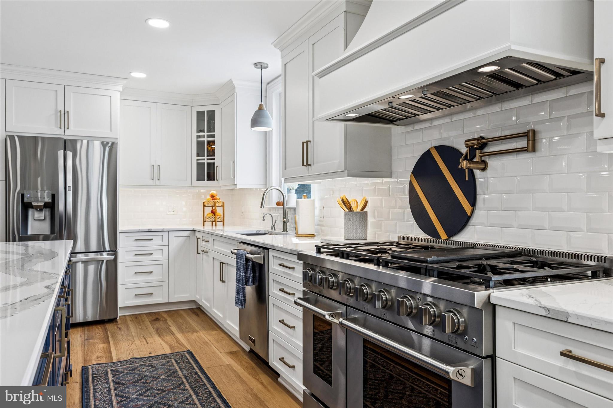 222 Windsor Way Doylestown, PA 18901 - Photo 8 of 42 a kitchen with stainless steel appliances granite countertop a stove and a refrigerator