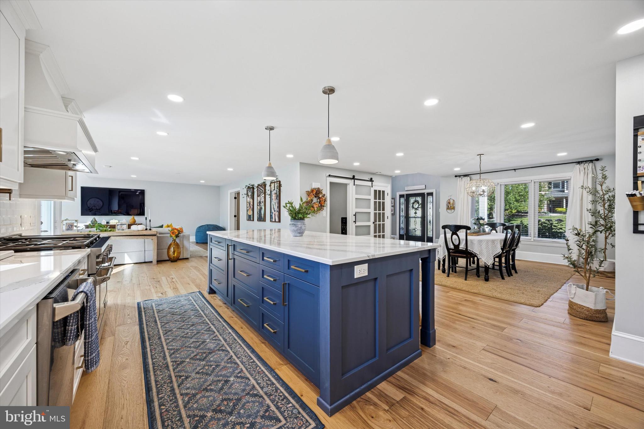 222 Windsor Way Doylestown, PA 18901 - Photo 9 of 42 a kitchen with stainless steel appliances granite countertop wooden cabinets a sink a stove and a wooden floors