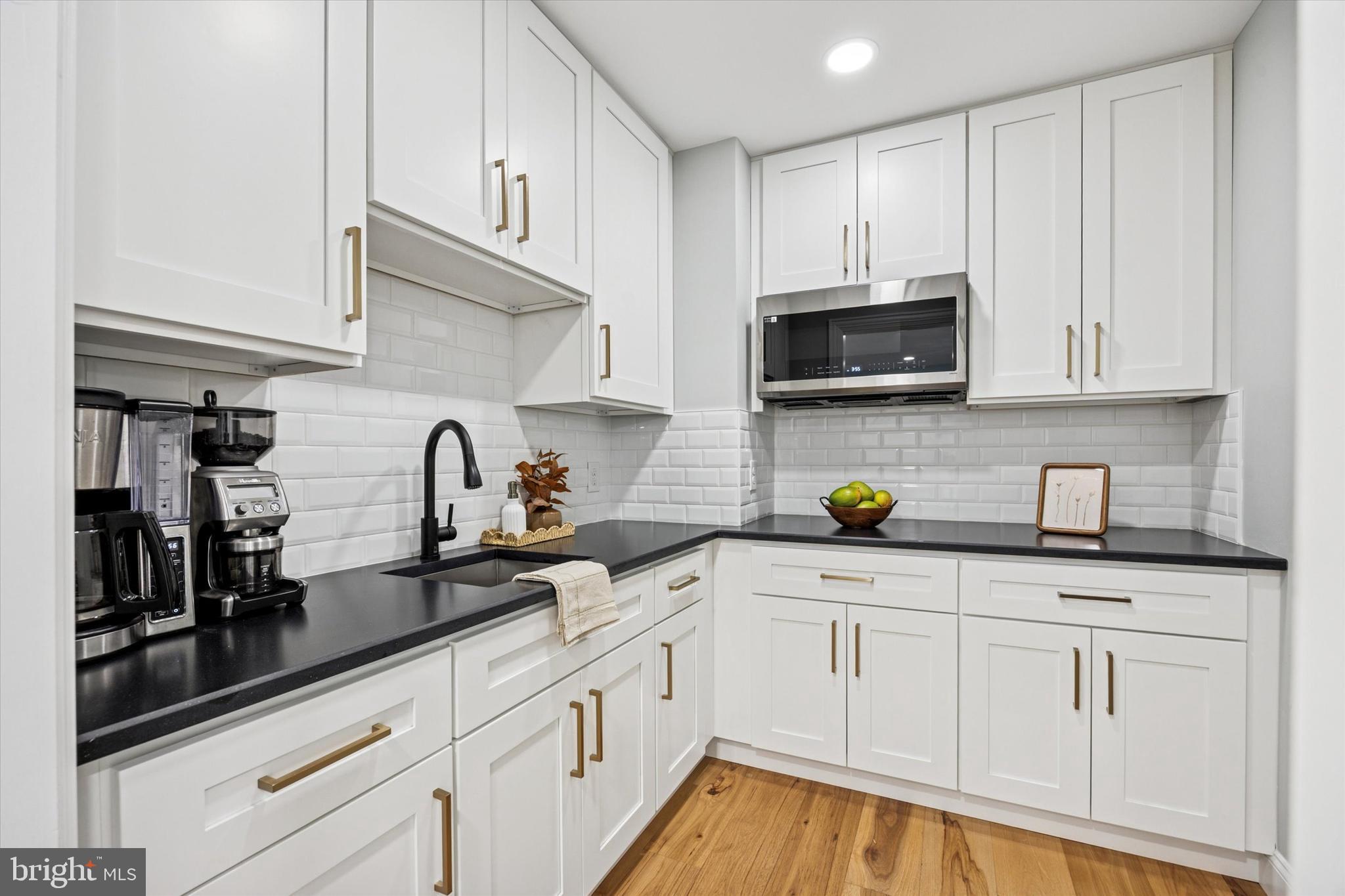 222 Windsor Way Doylestown, PA 18901 - Photo 10 of 42 a kitchen with white cabinets and a sink