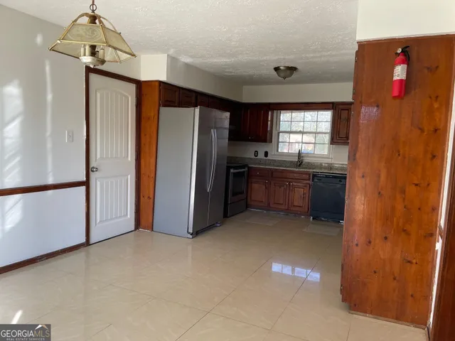 a kitchen with stainless steel appliances a refrigerator and a sink