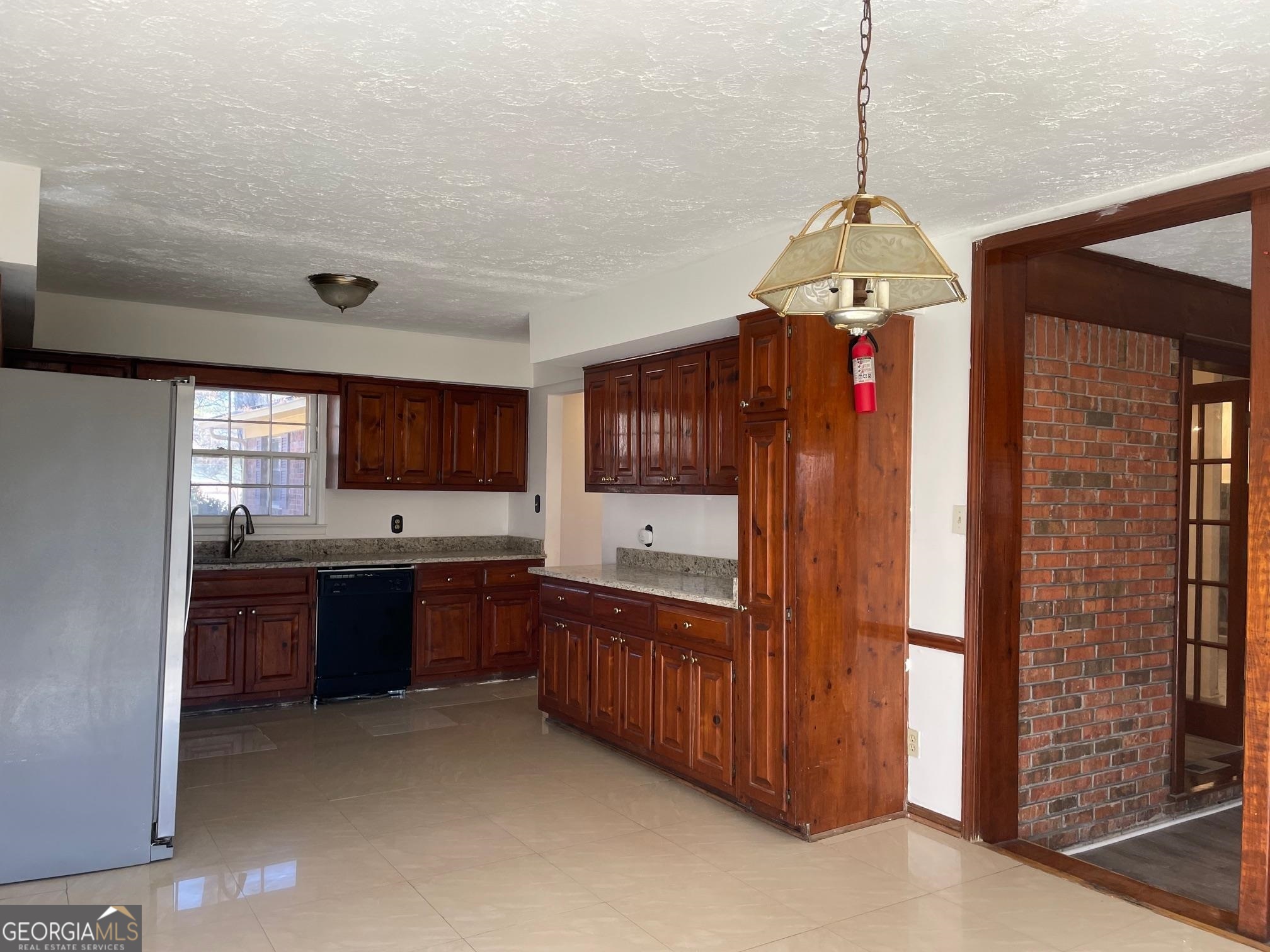 4231 Rue Dartagnan Stone Mountain, GA 30083 - Photo 18 of 23 a kitchen with stainless steel appliances granite countertop cabinets and window
