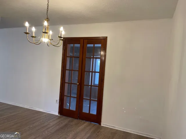 a view of a room with wooden floor and large window