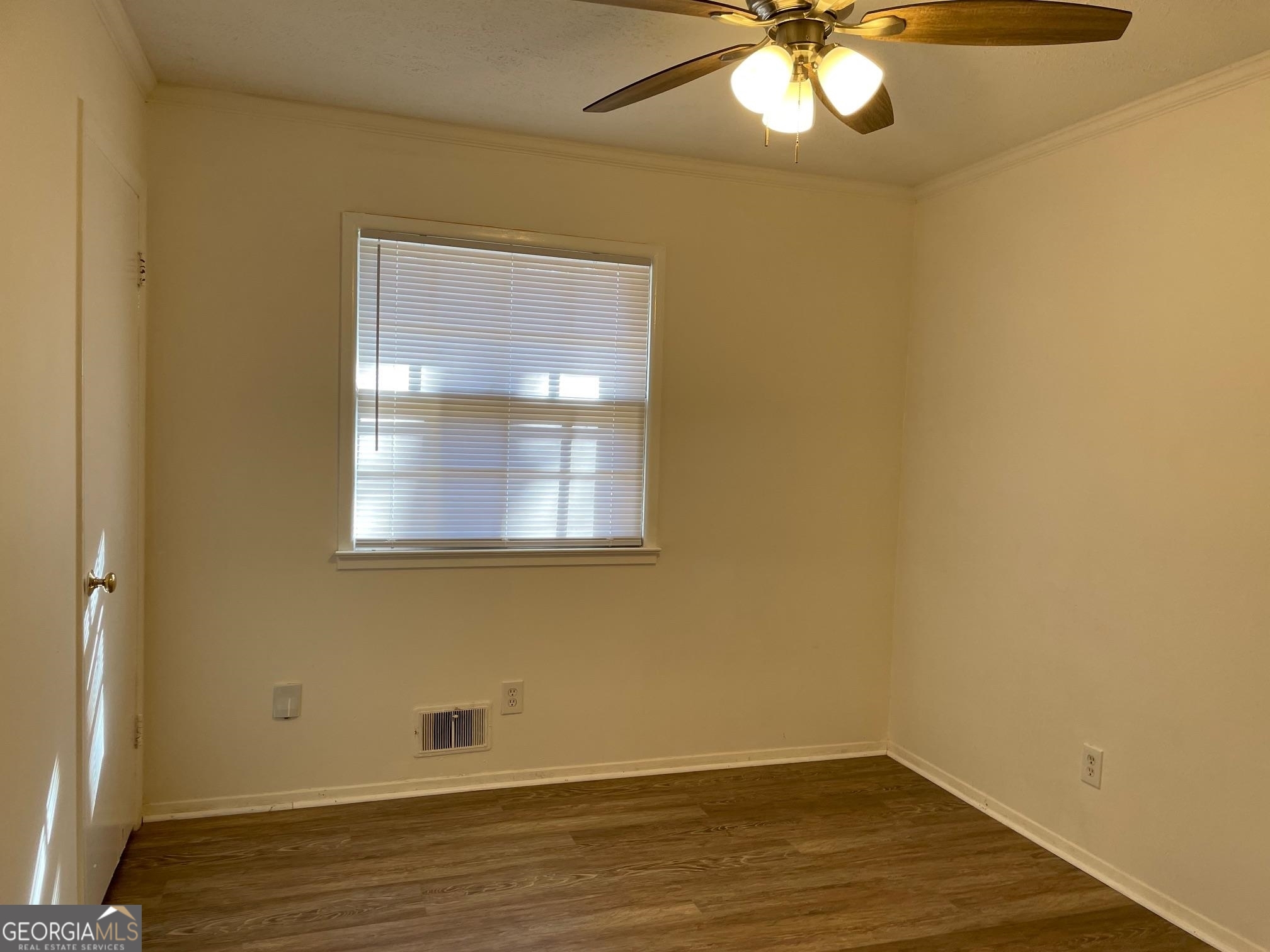 4231 Rue Dartagnan Stone Mountain, GA 30083 - Photo 9 of 23 a view of empty room with wooden floor and fan