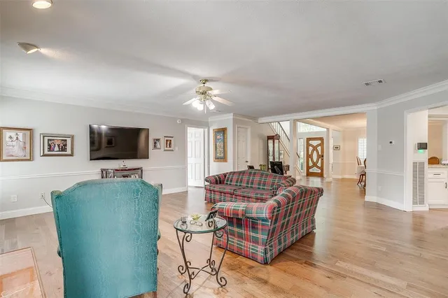 a kitchen with stainless steel appliances granite countertop a sink a stove and a wooden floors