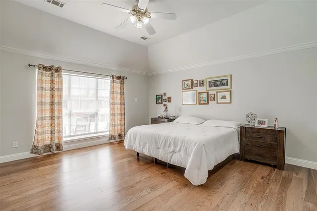 a bedroom with a large bed and a large window