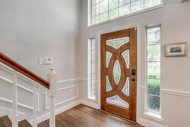 a view of an entryway with wooden floor and door