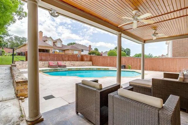 an aerial view of residential houses with outdoor space and trees