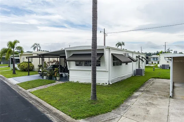 a view of a house with yard and sitting area