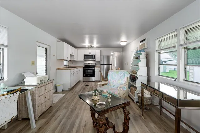 a kitchen with a table chairs stove and cabinets