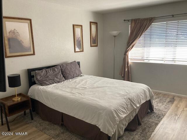 2670 Snow Slope Way Pinetop, AZ 85935 - Photo 16 of 18 a large bed sitting in a bedroom next to a window