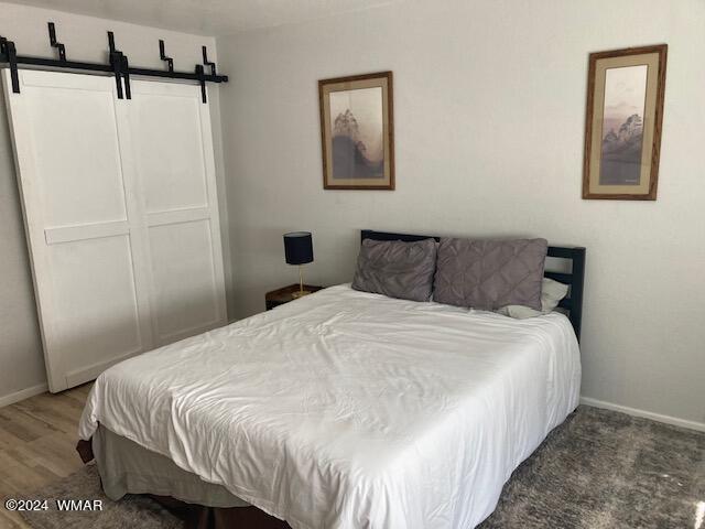 2670 Snow Slope Way Pinetop, AZ 85935 - Photo 18 of 18 a bedroom with a bed and painting on the wall