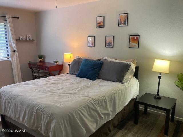 2670 Snow Slope Way Pinetop, AZ 85935 - Photo 8 of 18 a bedroom with a bed and a lamp