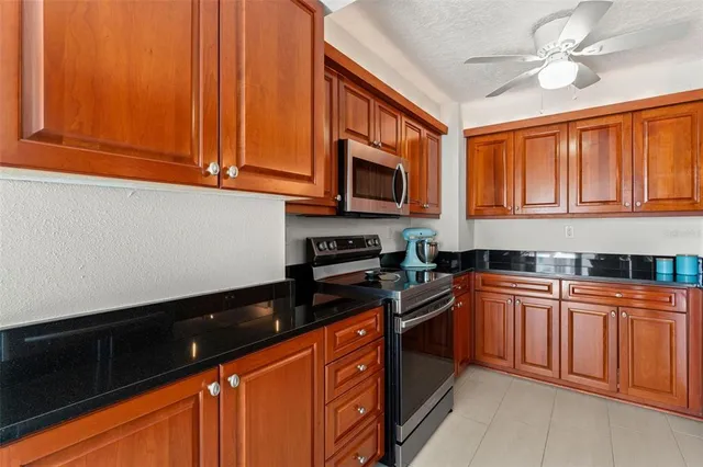 a kitchen with stainless steel appliances granite countertop a sink stove and microwave